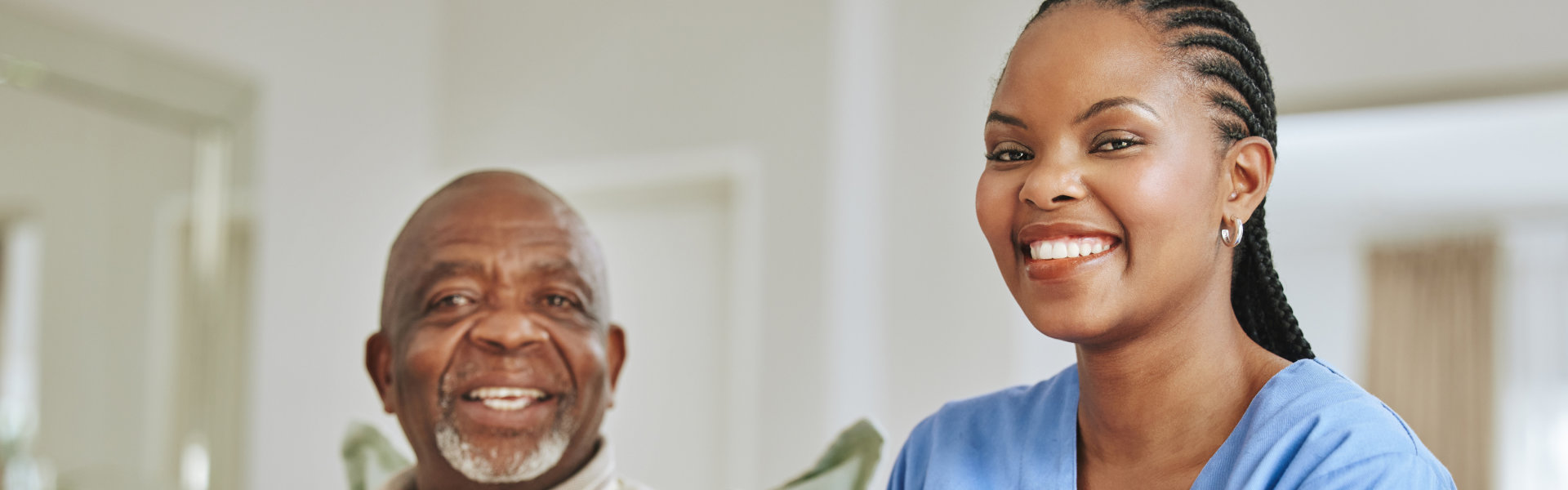senior man and caregiver smiling
